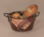 Bread in Metal Basket by Evelyne Andriamasy
