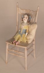 Doll Sitting on Cream Chair by Gale Elena Bantock