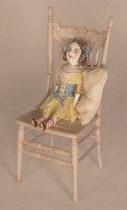 Doll Sitting on Cream Chair by Gale Elena Bantock