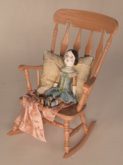 Doll Sitting in Rocking Chair by Gale Elena Bantock
